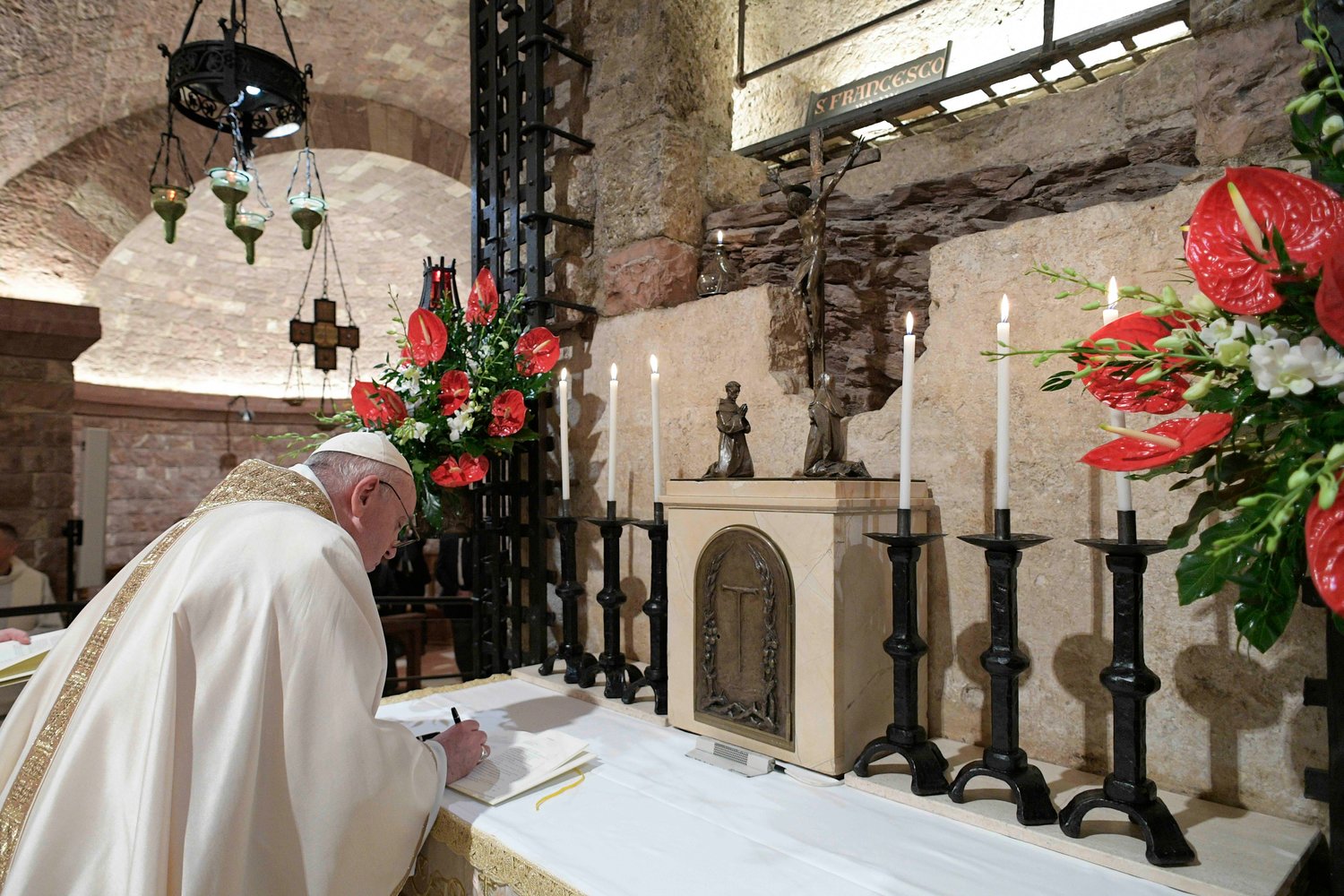 Pope Francis signs his new encyclical, "Fratelli Tutti, on Fraternity and Social Friendship" after celebrating Mass at the Basilica of St. Francis in Assisi, Italy, Oct. 3, 2020.